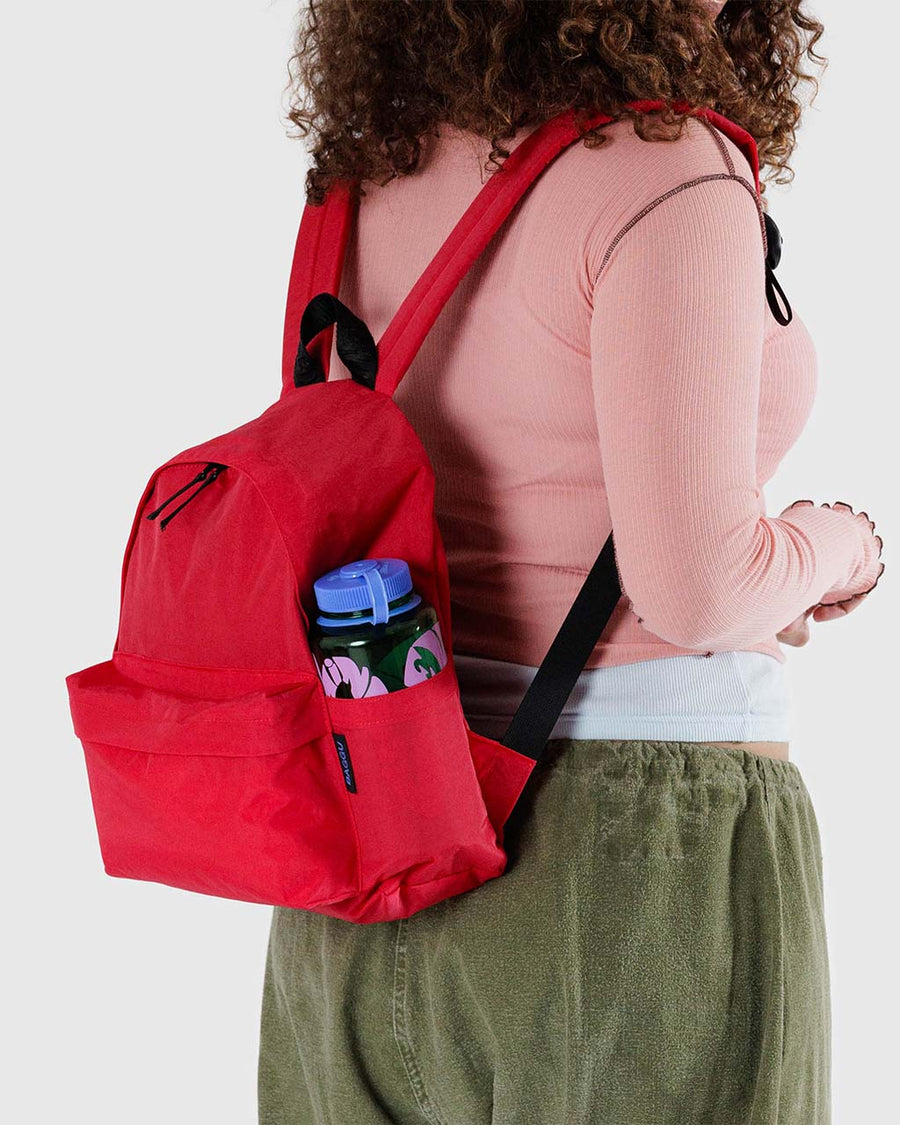 model wearing candy apple medium nylon backpack