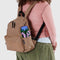 model wearing light taupe brown medium nylon backpack