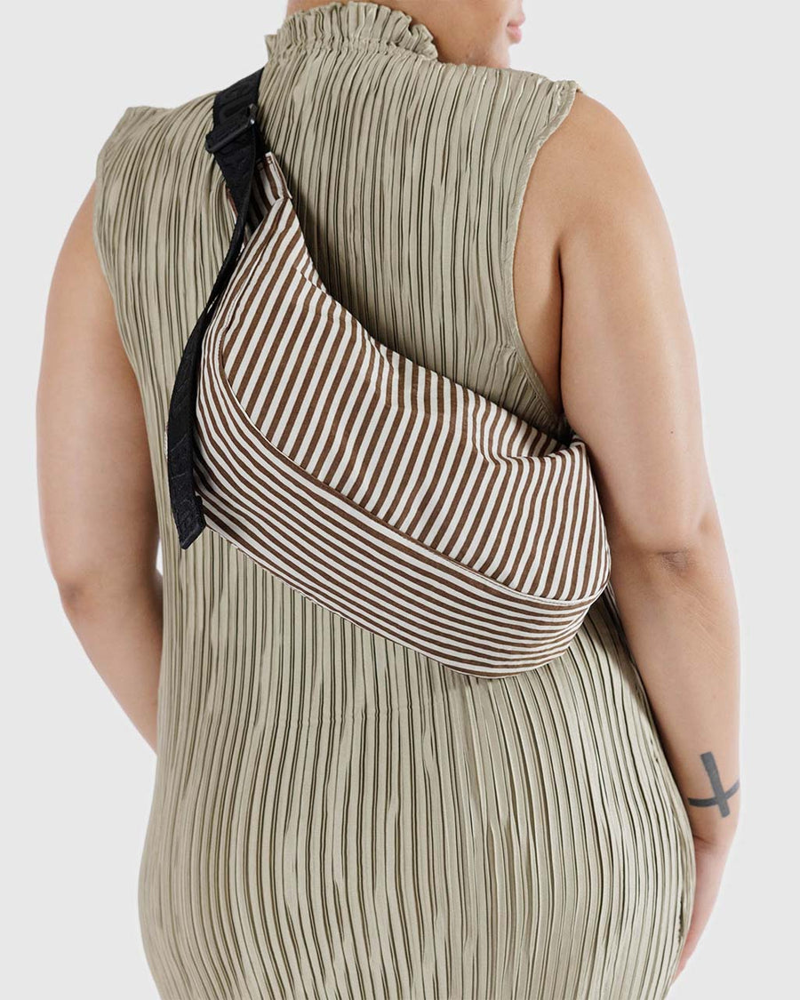 model wearing two tone vertical brown stripe medium crescent bag