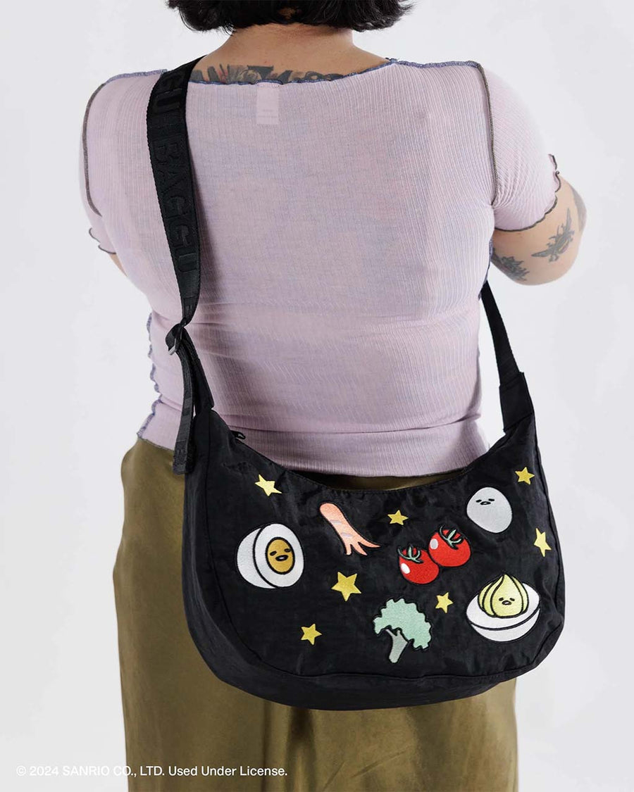 model wearing embroidered gudetama print medium nylon crescent bag