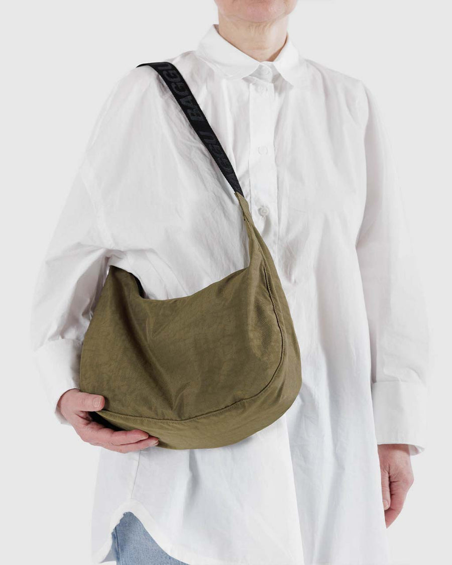 model wearing dark green medium nylon crescent bag