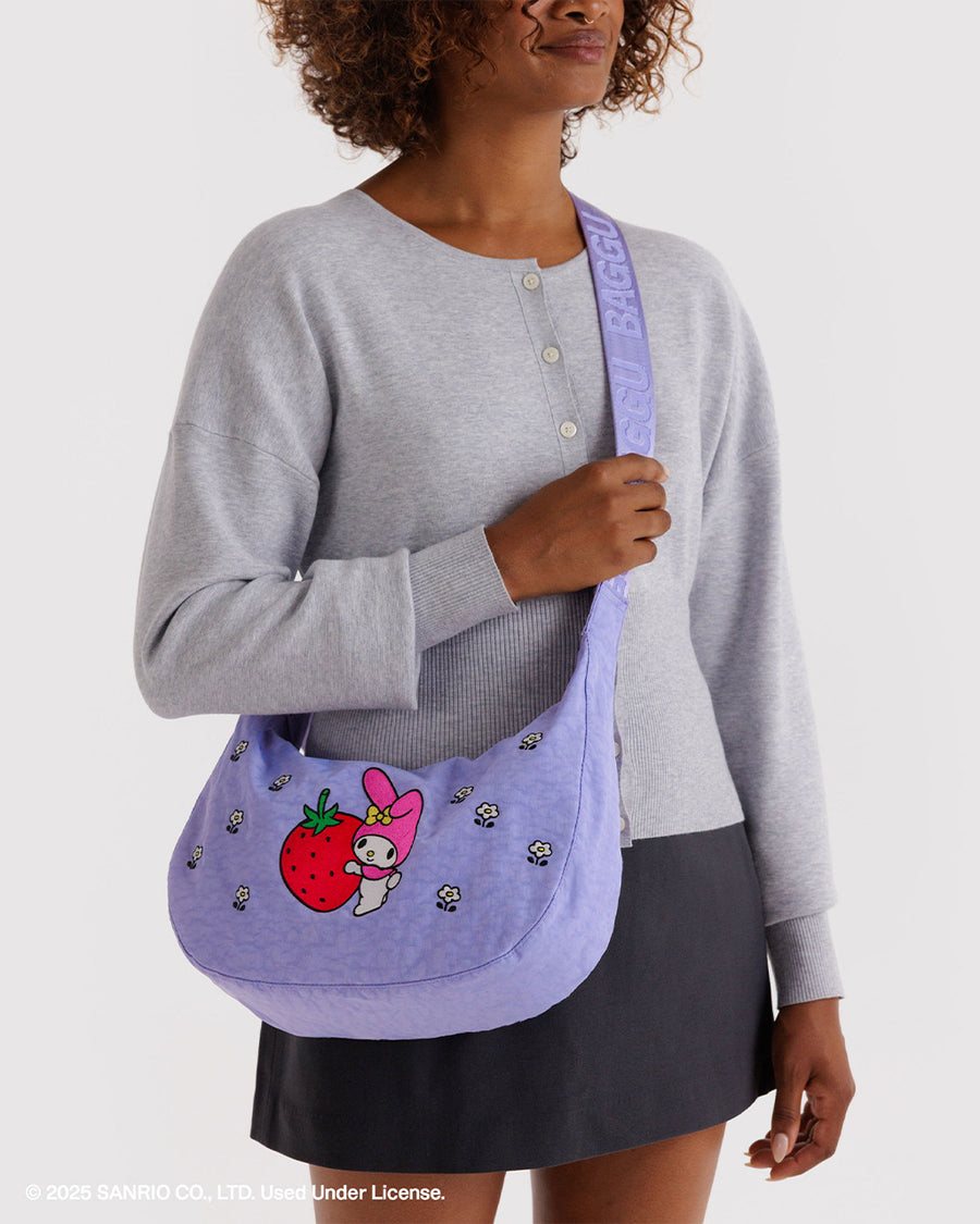 model wearing lavender medium nylon crescent bag with embroidered my melody hugging a strawberry and white flower print as a crossbody