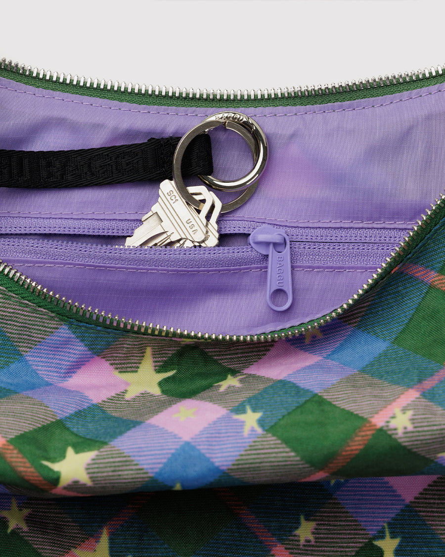 interior key chain of medium crescent bag with green, blue and pink plaid with yellow stars