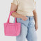 model carrying bright pink mini baggu cloud bag