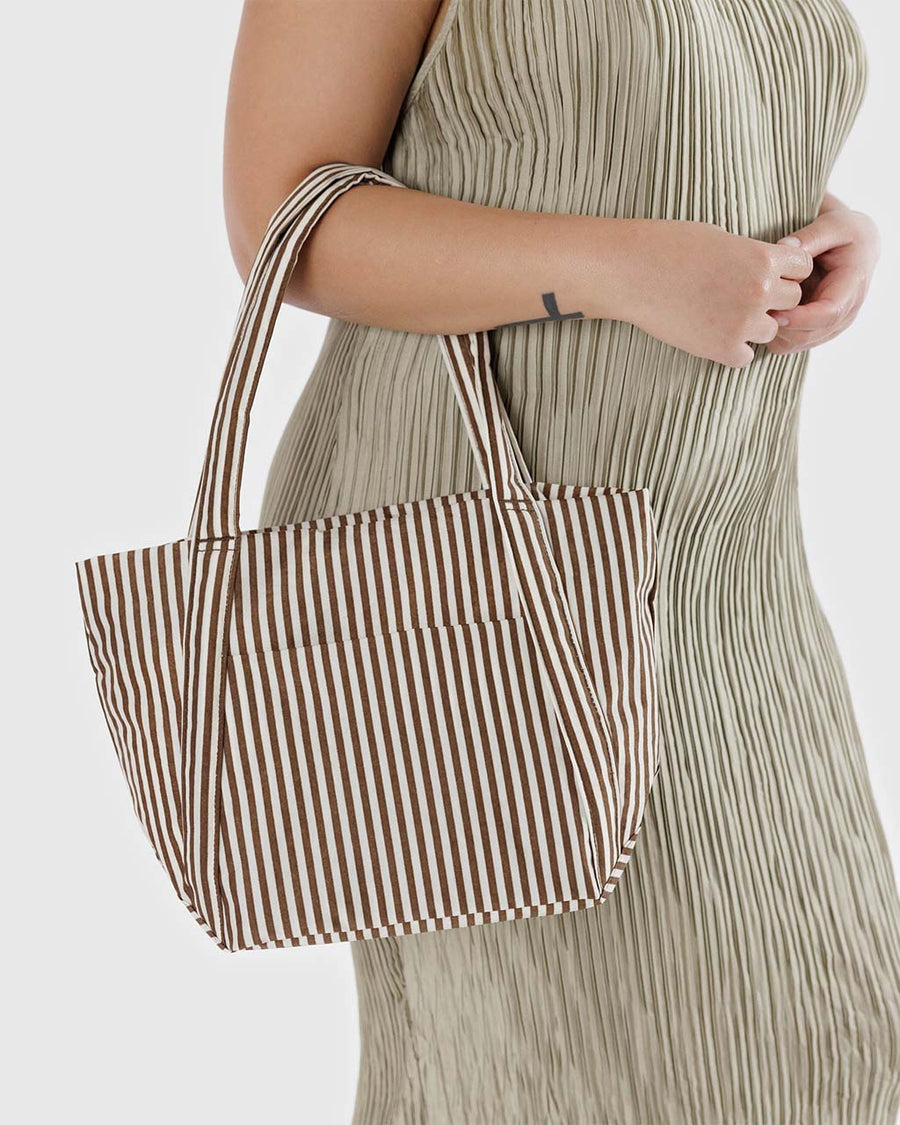 model holding two tone brown vertical stripe mini cloud bag