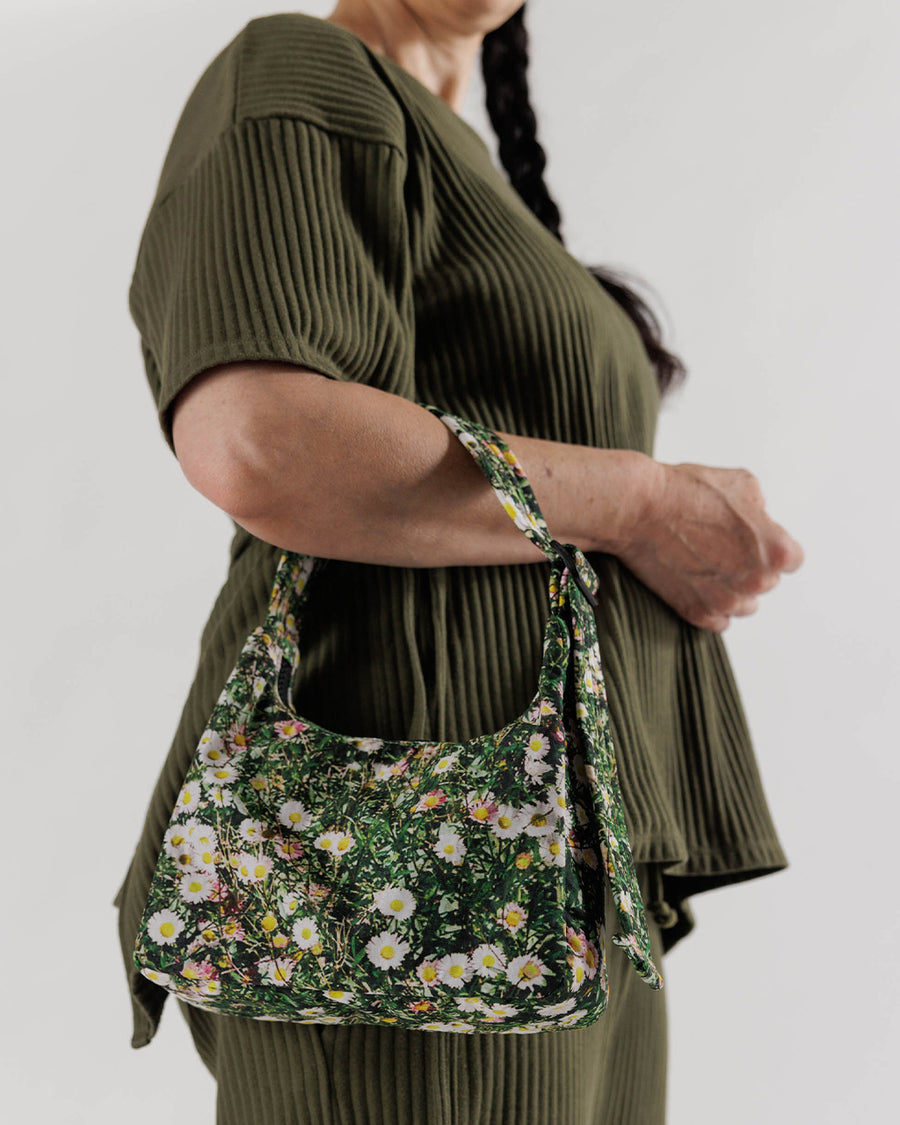 model holding realistic daisy mini nylon shoulder bag