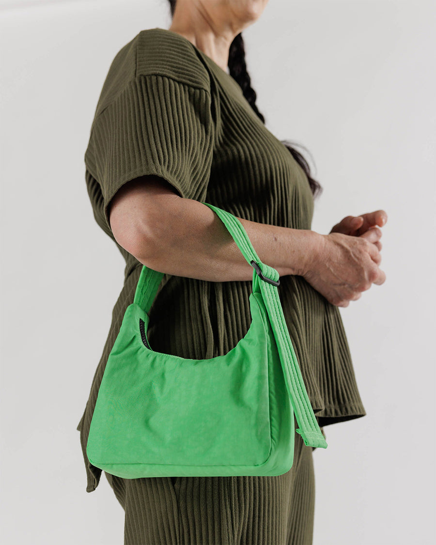 model holding light green mini nylon shoulder bag