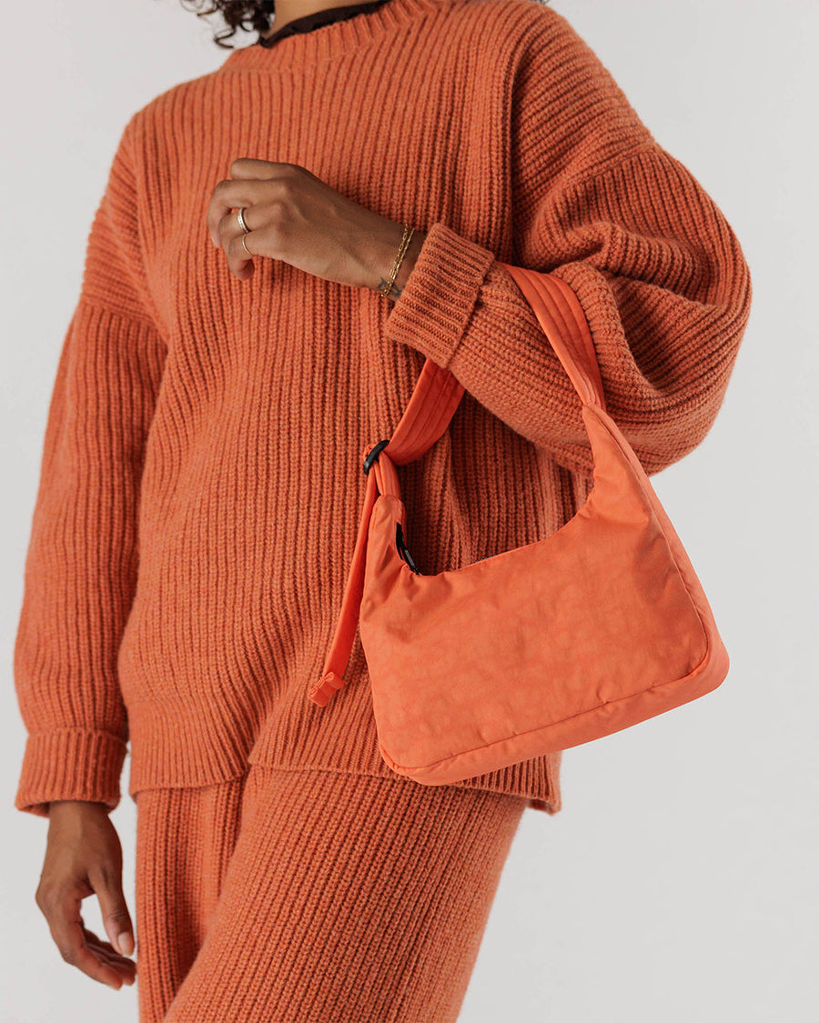 model holding coral mini nylon shoulder bag