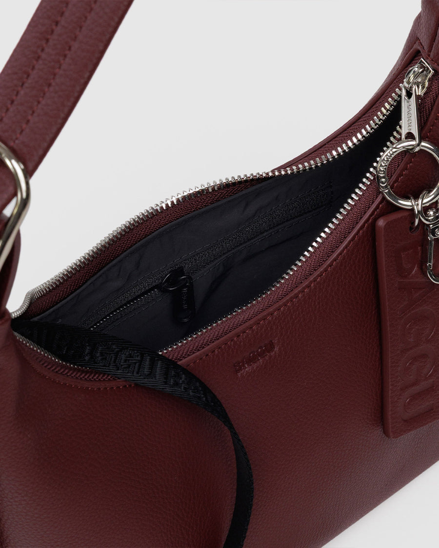 black key leash inside of mahogany recycled leather mini nylon shoulder bag with matching strap and trim