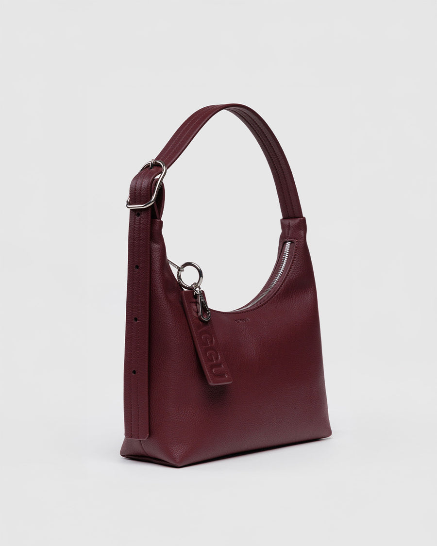 side view of mahogany recycled leather mini nylon shoulder bag with matching strap and trim