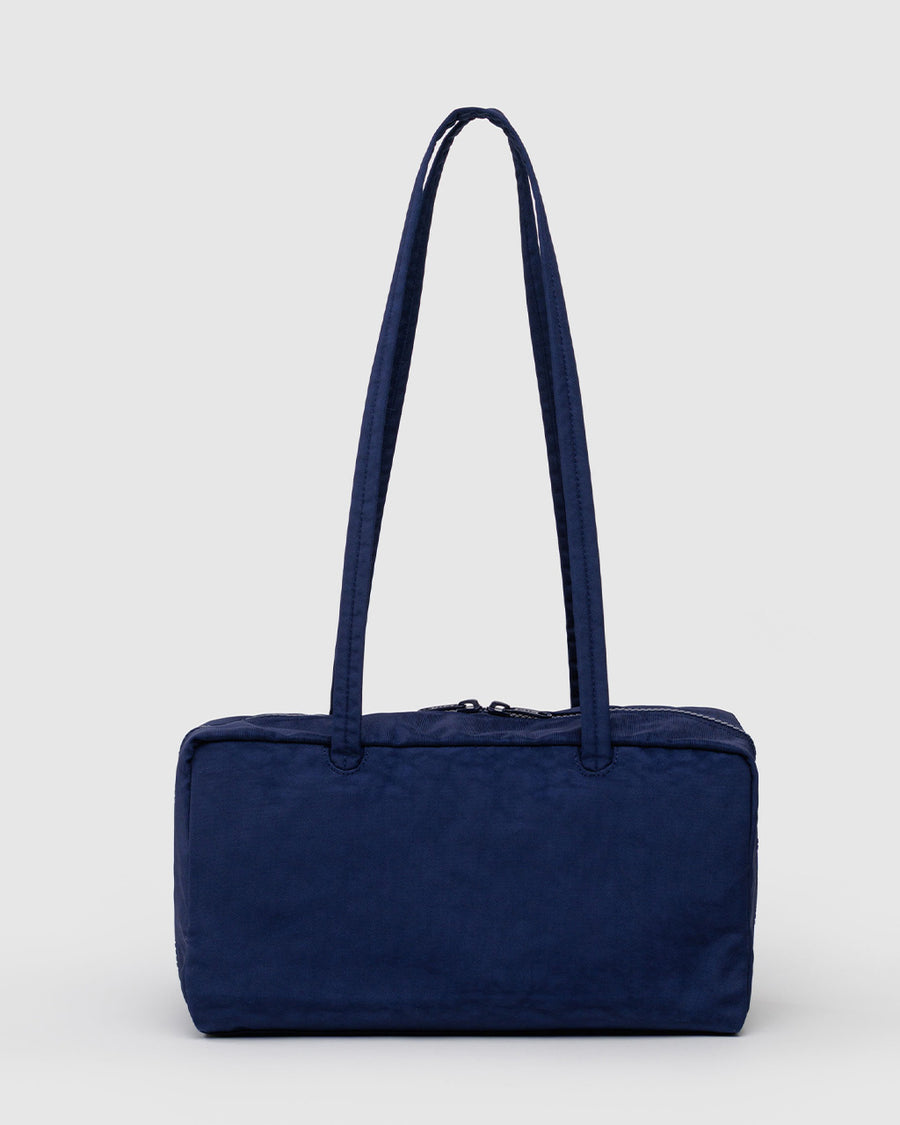 backview of navy nylon bowler bag with embroidered hello kitty talking on a red phone