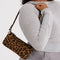 model carrying nylon leopard pochette bag with smiley charm and adjustable shoulder strap
