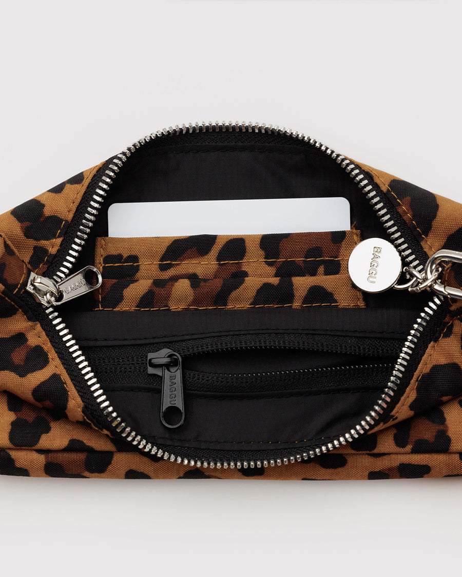 interior of nylon leopard pochette bag with smiley charm and adjustable shoulder strap