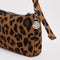up close of charm on nylon leopard pochette bag with smiley charm and adjustable shoulder strap