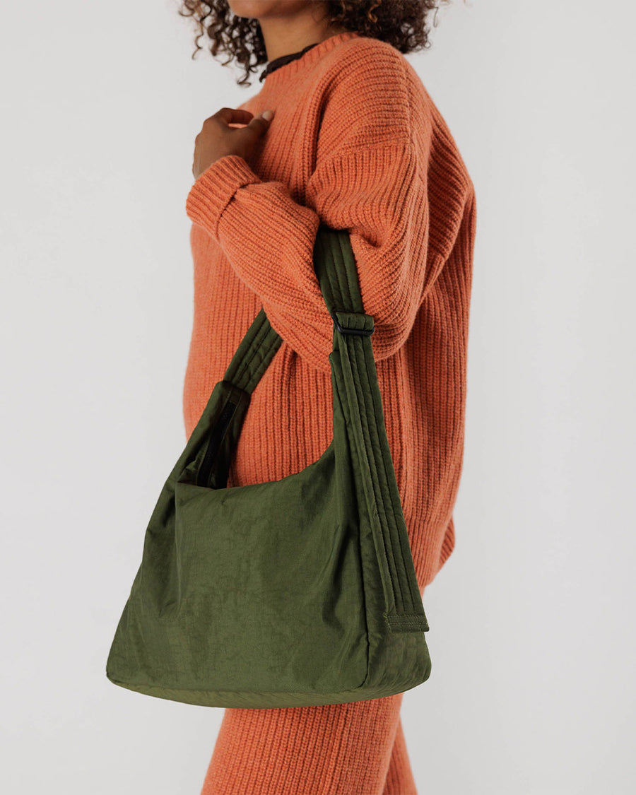 model wearing green nylon shoulder bag