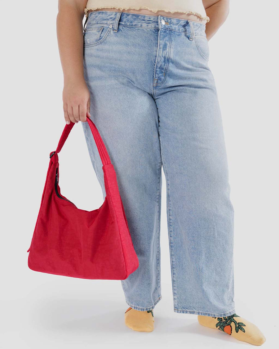 model carrying candy apple red nylon shoulder bag