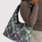 model carrying green and pink plaid star nylon shoulder bag