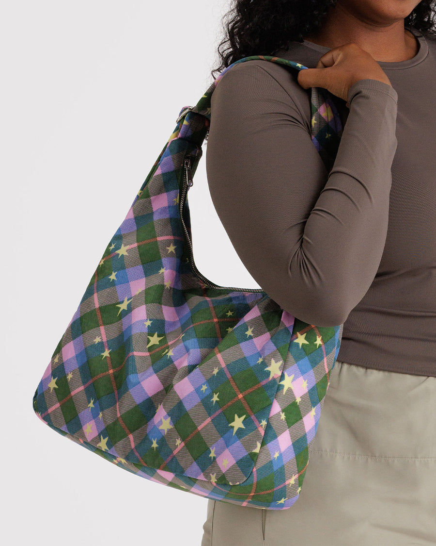model carrying green and pink plaid star nylon shoulder bag