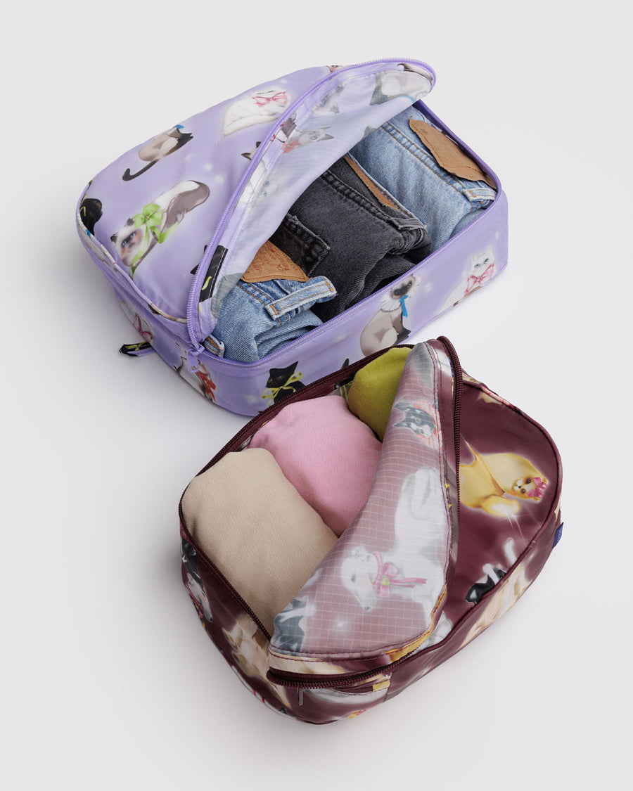 set of two packing cubes: small maroon fancy dogs and large lilac fancy cats with items inside