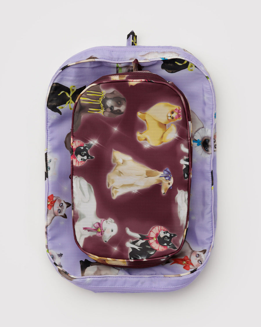 flattened set of two packing cubes: small maroon fancy dogs and large lilac fancy cats
