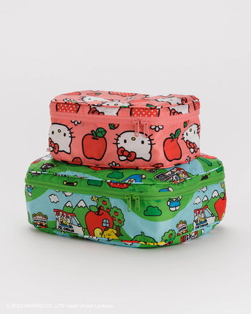 set of two packing cubes: small pink hello kitty apple and medium green hello kitty and friends scene