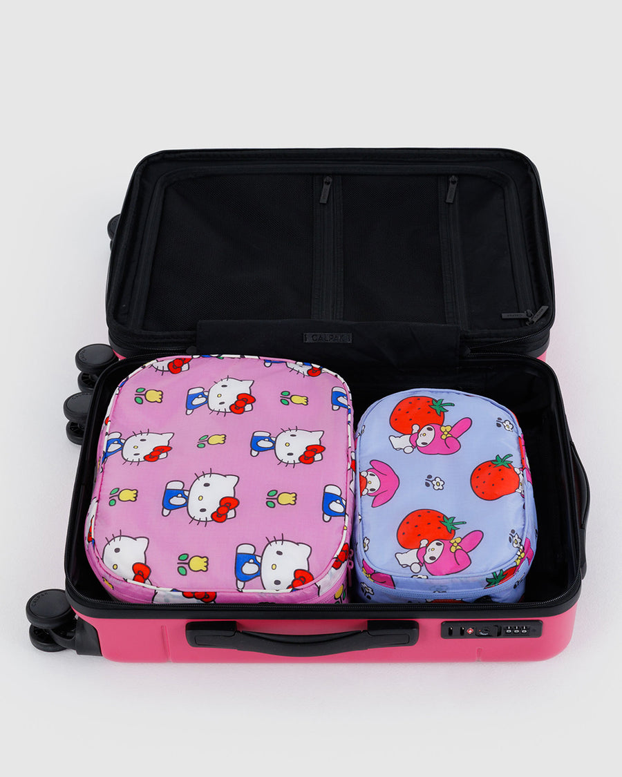 set of two packing cube set: large pink hello kitty with yellow tulips and small light blue my melody hugging a strawberry in a suitcase