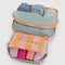set of 2 colorful multi stripe packing cubes filled with items