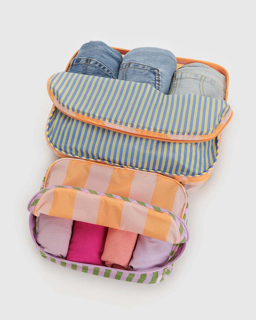 set of 2 colorful multi stripe packing cubes filled with items