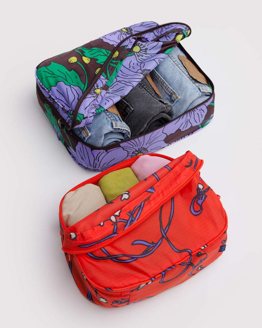 set of two packing cubes: small coral snapdragon and large maroon poppy with clothing inside
