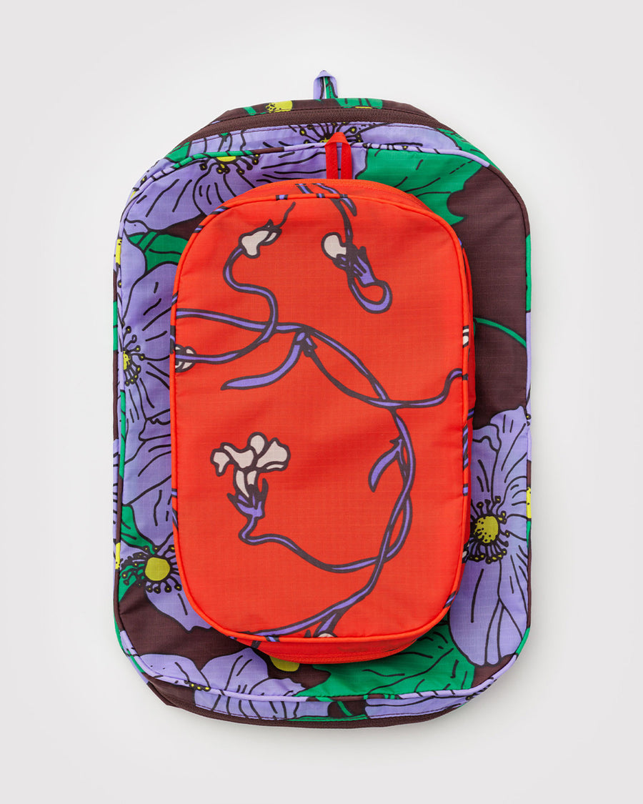 flattened set of two packing cubes: small coral snapdragon and large maroon poppy