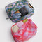 set of two packing cubes: small pink plaid star and large blue/green plaid star with clothing inside