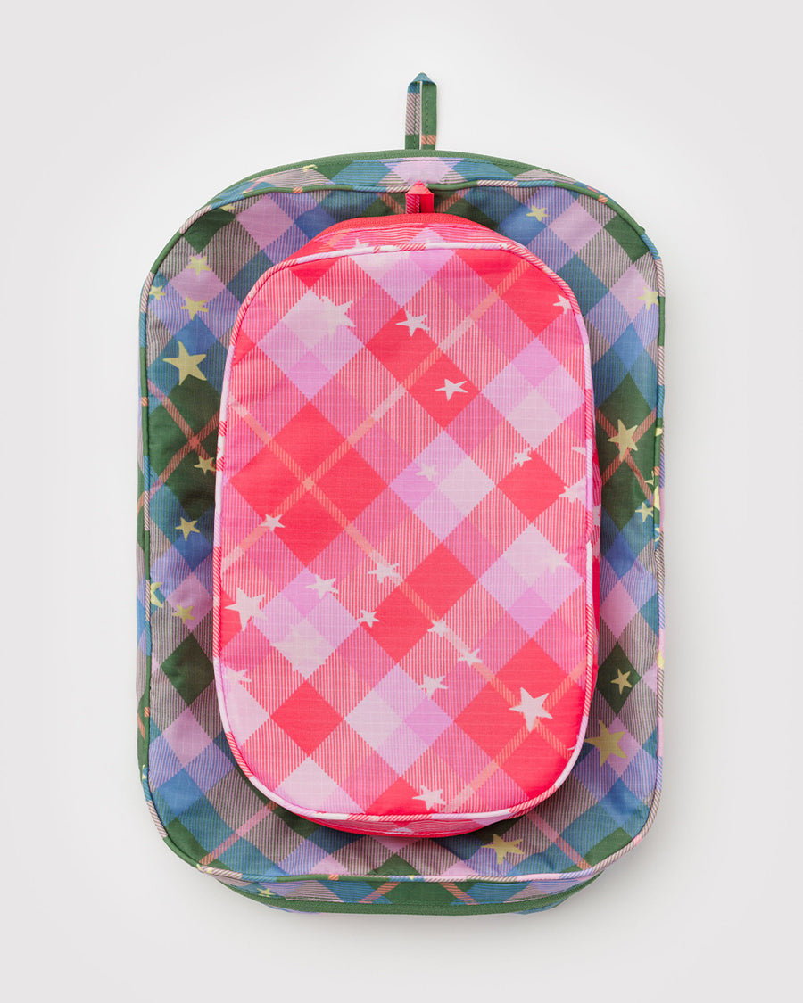 flattened set of two packing cubes: small pink plaid star and large blue/green plaid star
