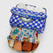 set of 2 packing cubes: white vacation tiles and blue checkered cherry print with items inside