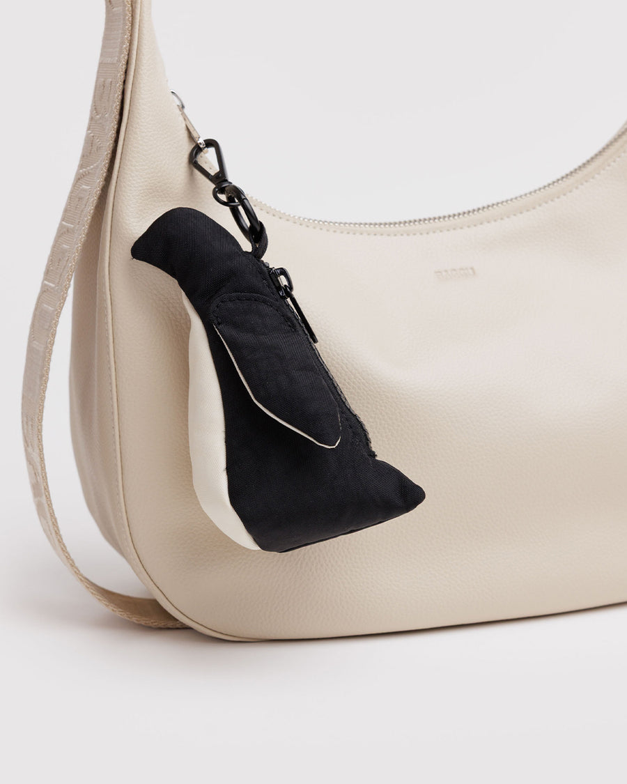 penguin bag charm on cream bag