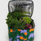 periwinkle puffy cooler with orange tree print with veggies inside