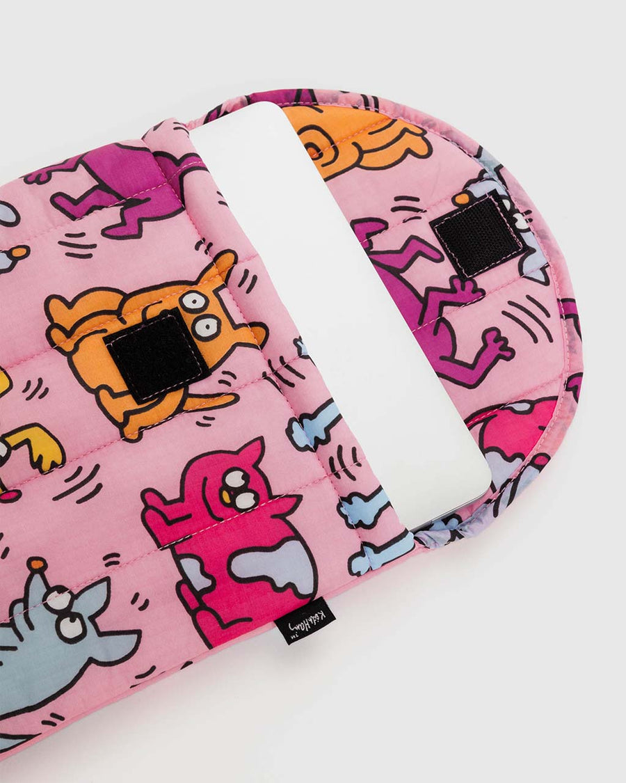 opened pink 13 in. puffy laptop sleeve with colorful pets print with laptop inside