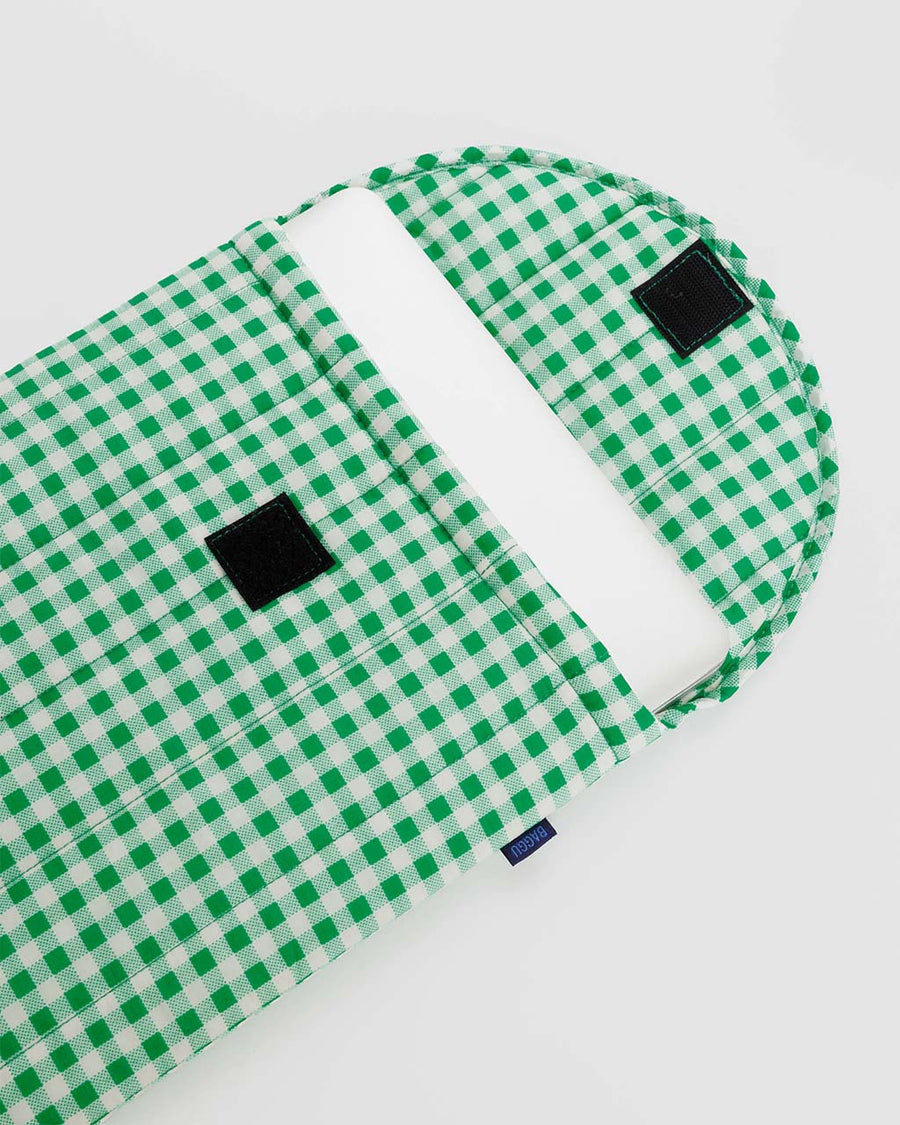 inside closure of white and green gingham puffy 16 in. laptop sleeve with laptop inside