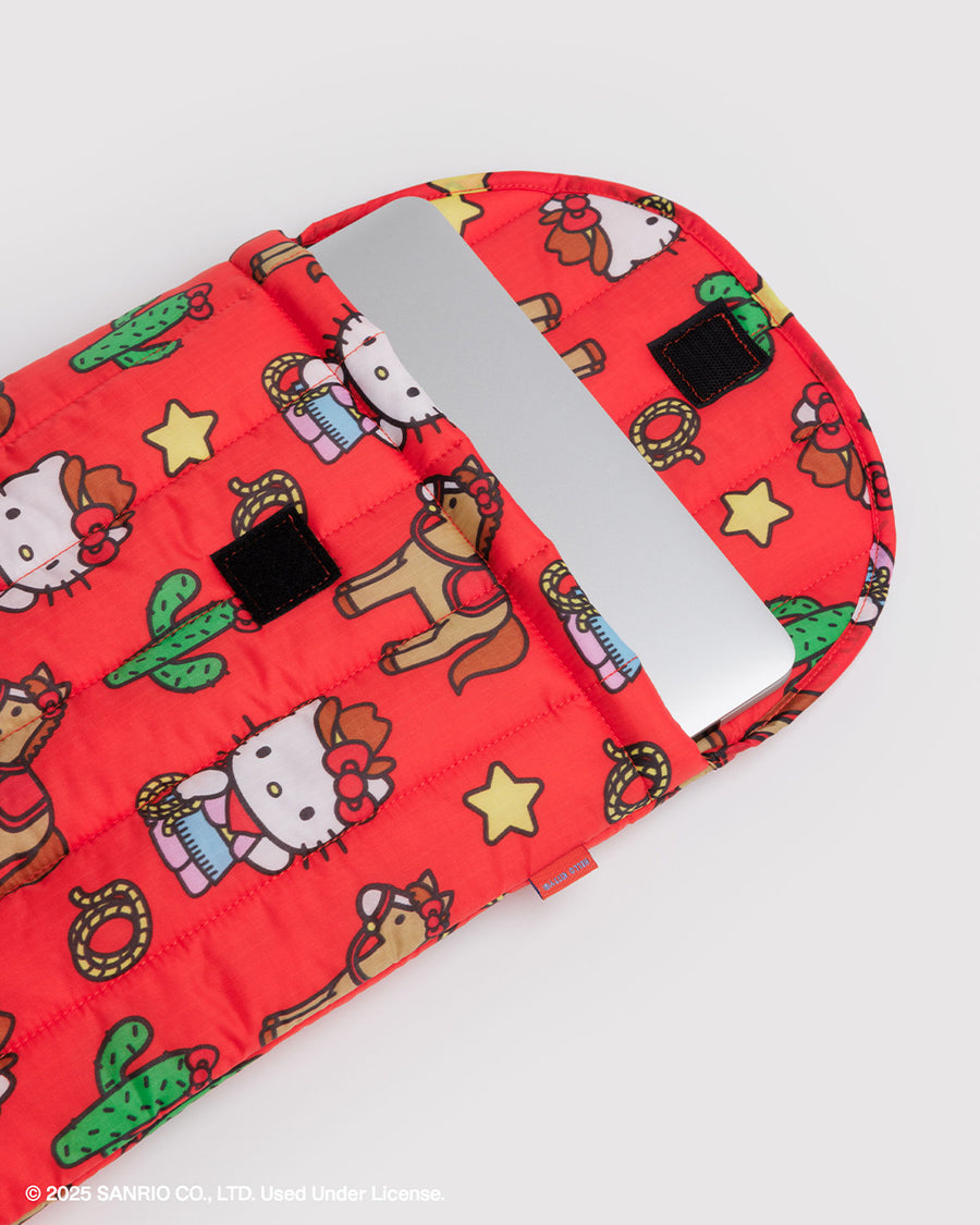 coral 16 in. puffy laptop sleeve with western hello kitty print with laptop sticking out. 