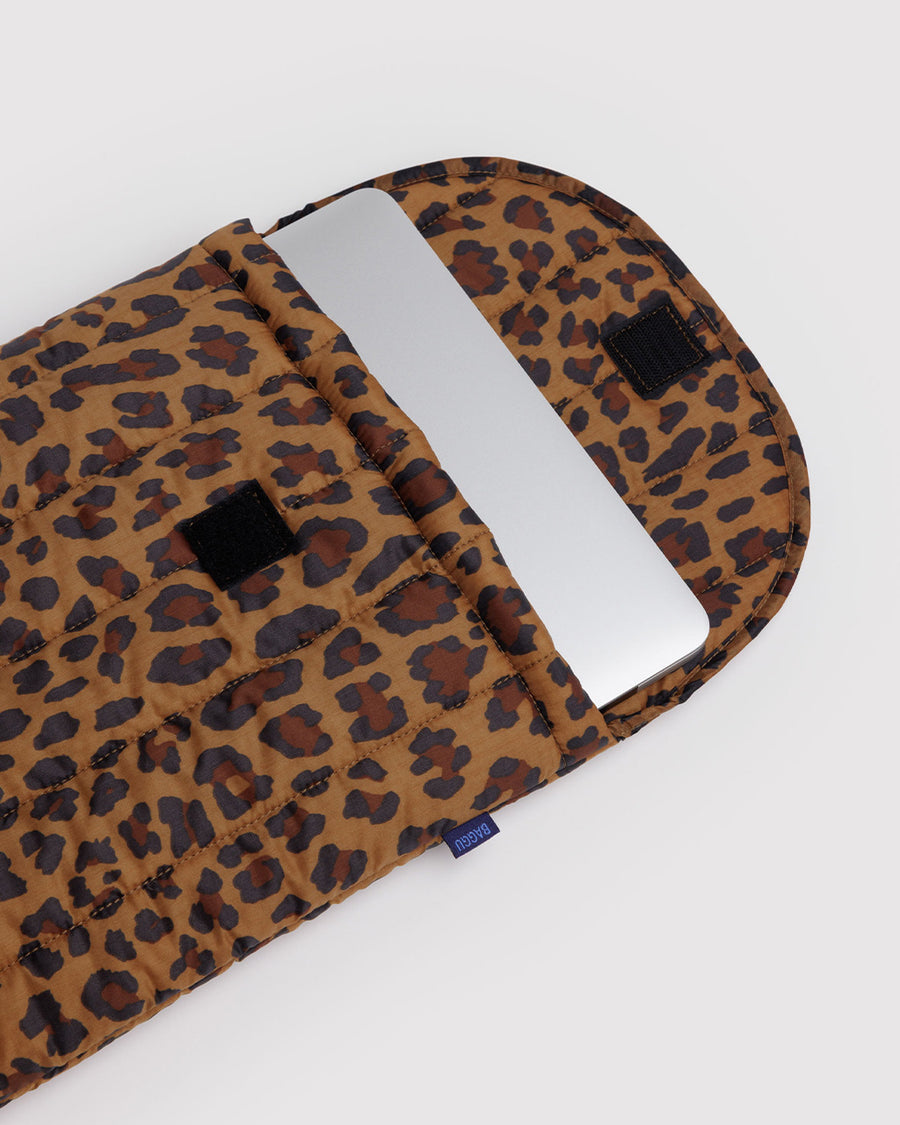 leopard 16 in. puffy laptop sleeve with laptop sticking out.