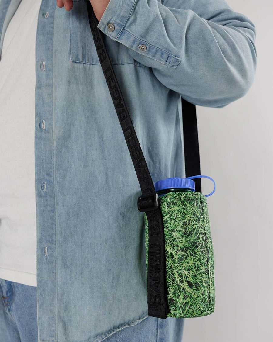 model wearing realistic grass puffy water bottle sling