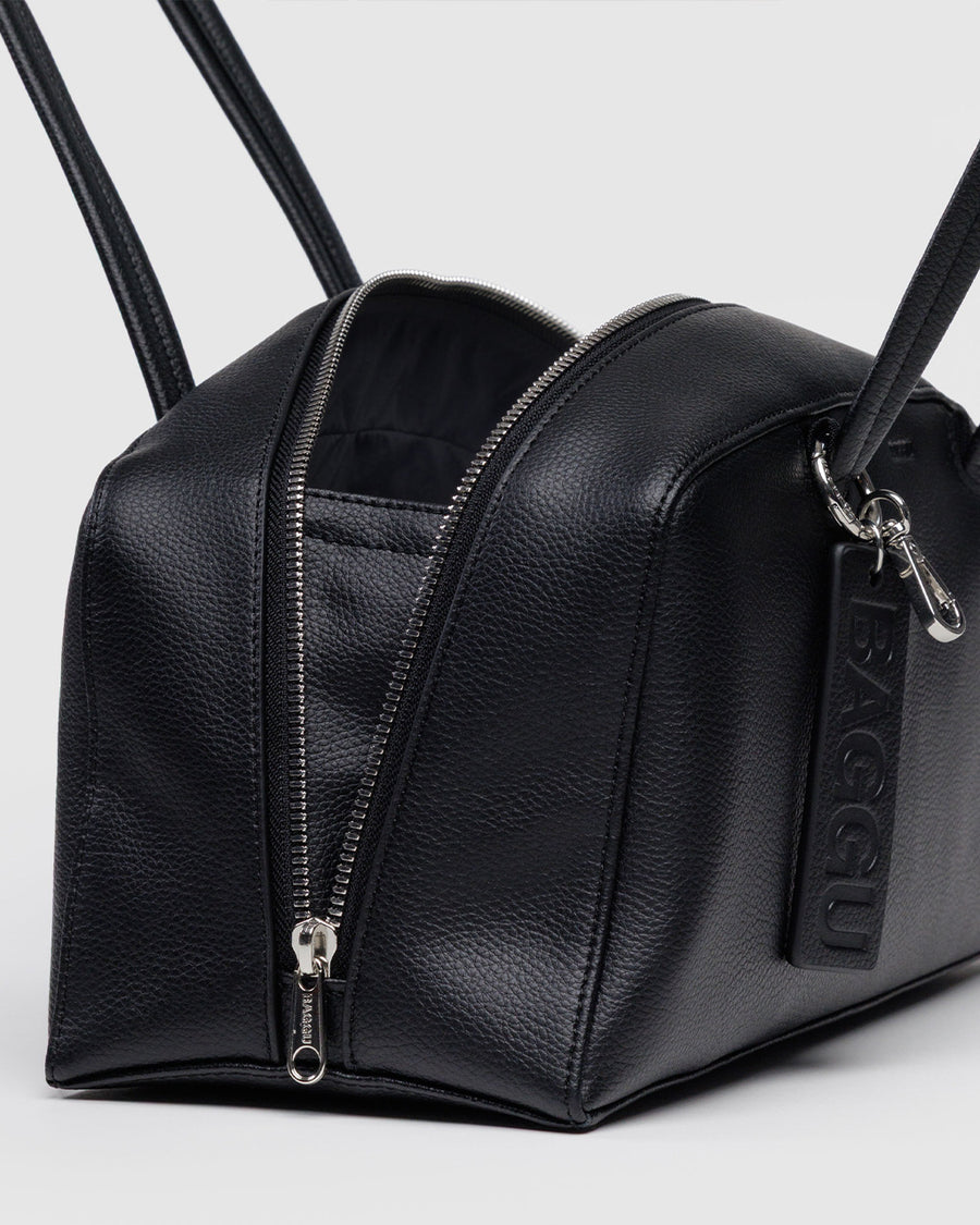 side view of medium black recycled dome bowler bag with silver charm clasp