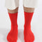 model wearing candy red ribbed socks
