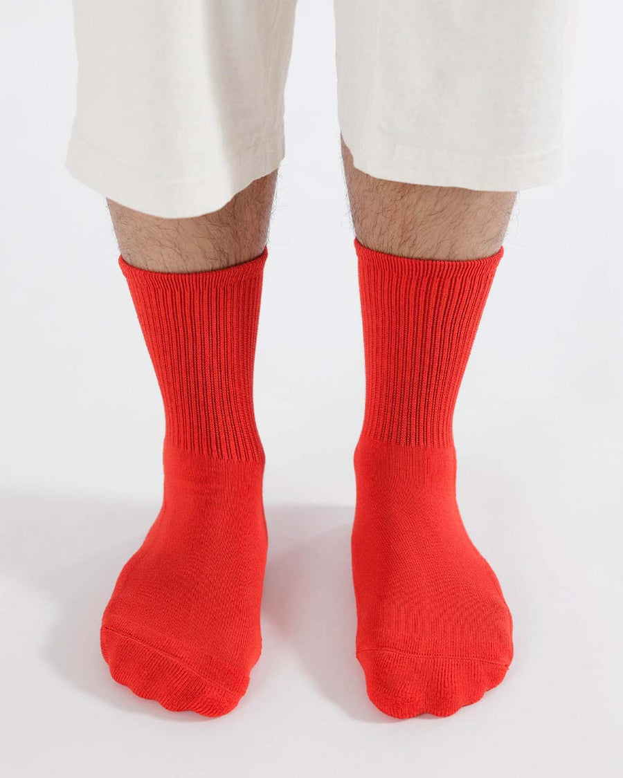 model wearing candy red ribbed socks