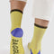 model wearing light yellow ribbed socks with black, blue and beige accents