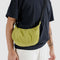 model wearing lemongrass small nylon crescent bag as a crossbody