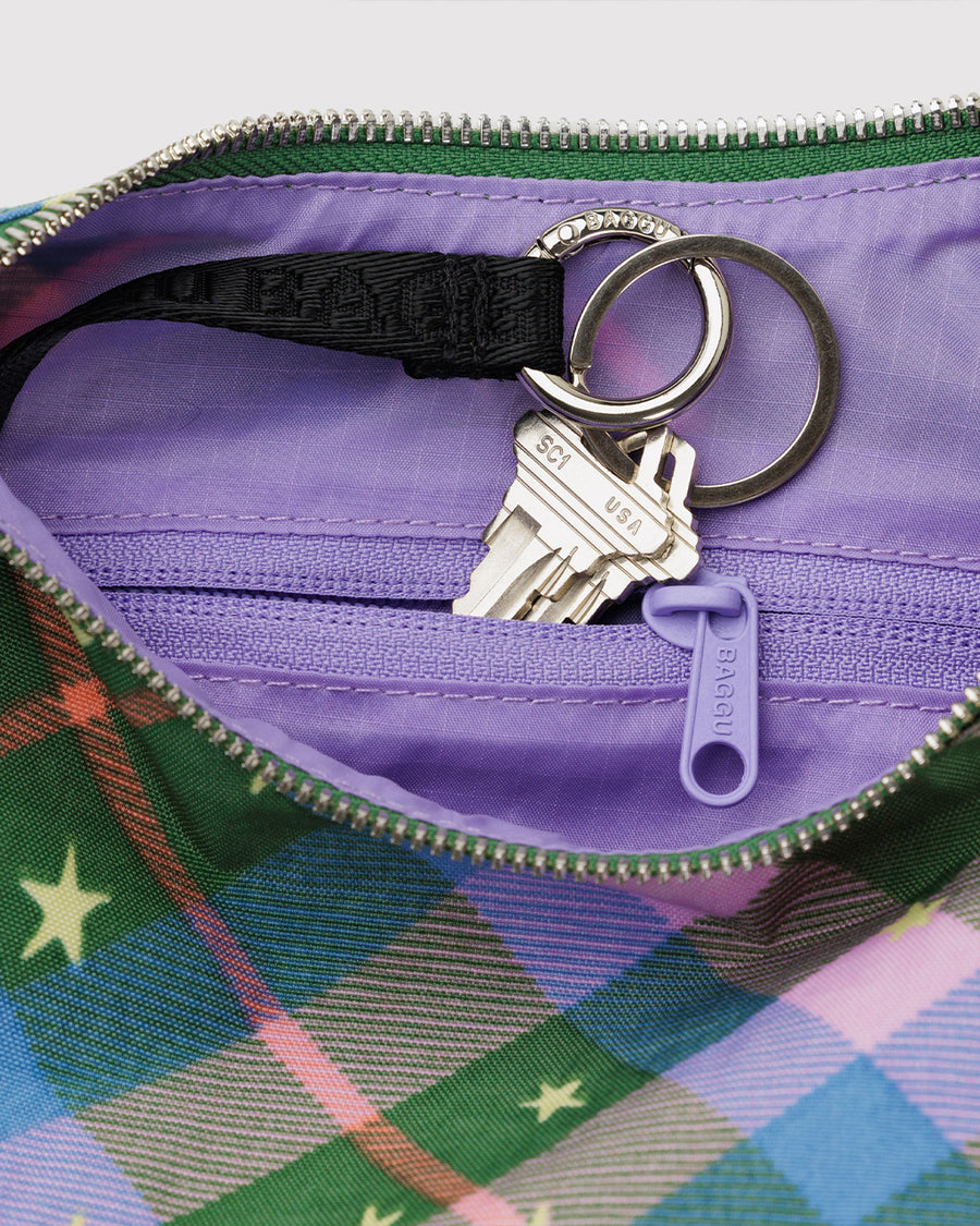 interior key leash on pink, green and blue plaid small crescent bag with black adjustable strap