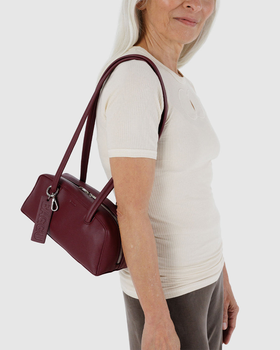 model carrying mahogany small dome recycled leather bowler bag with silver charm clasp