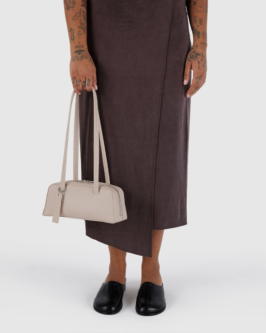 model holding stone small dome recycled leather bowler bag with silver charm clasp