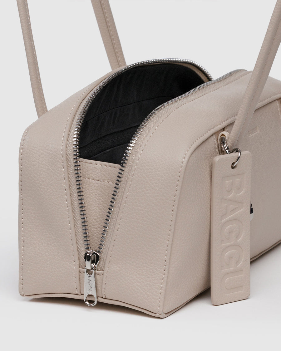 side view of stone small dome recycled leather bowler bag with silver charm clasp