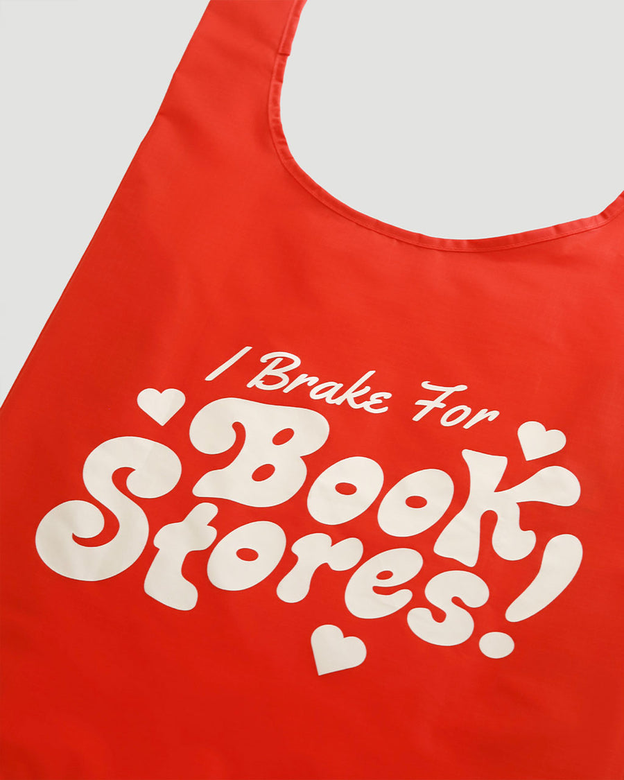 side view of red standard baggu with white 'i brake for bookstores!